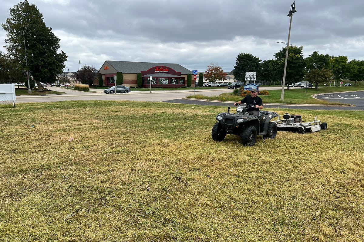 a landscaper removing brush