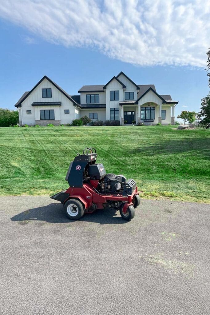 a lawn mower near a yard with a thatching attachment