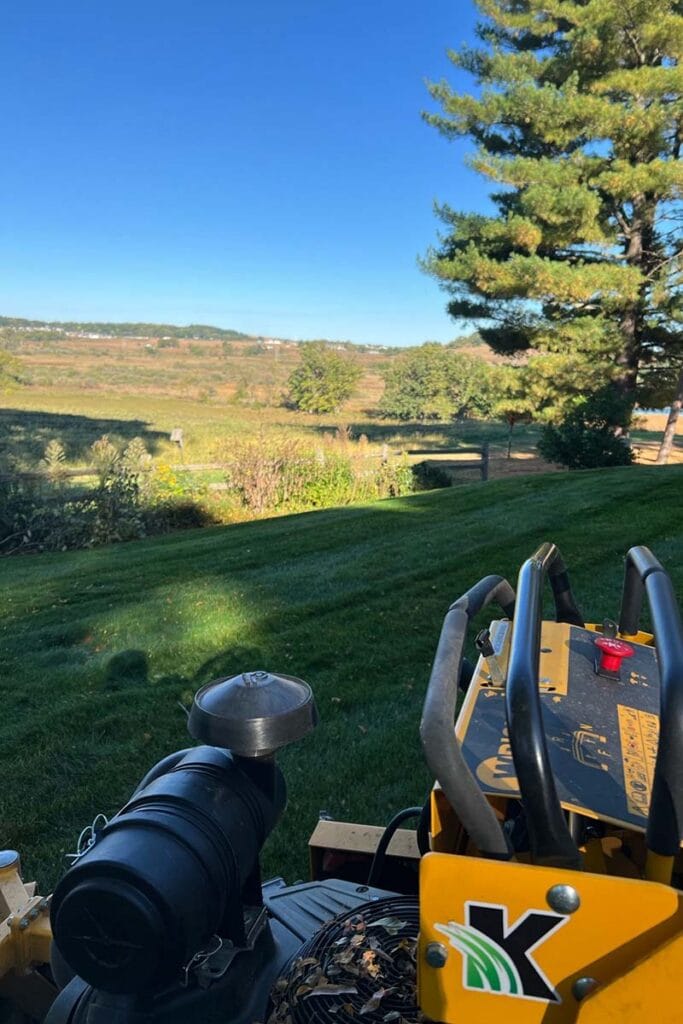 a Kampmeier lawn mower near a mowed lawn