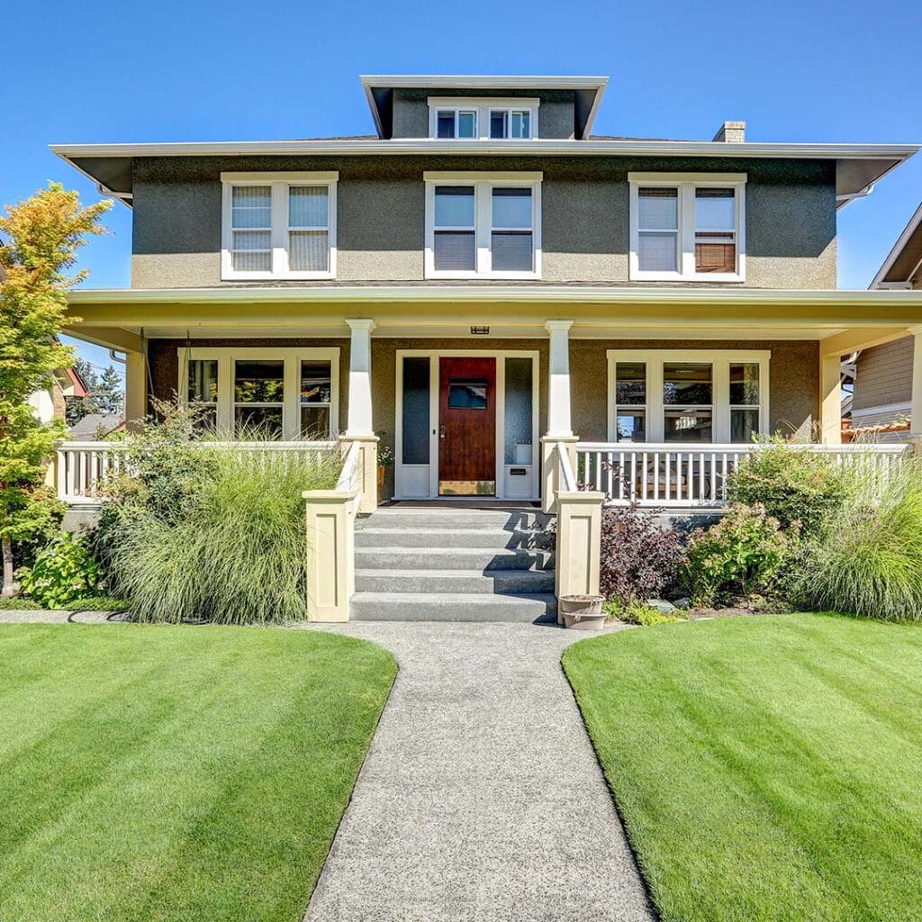 a landscaped home with green lawn