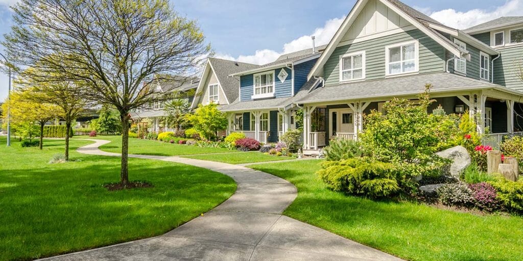 a landscaped home with green lawn